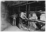 Lewis Hine child labor: Putting Bottles into the Annealing Oven. An Indianapolis Glass Works, 1 A.M. Location: Indianapolis, Indiana.