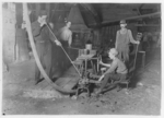 Lewis Hine child labor: Glass Blower and Mold Boy. Boy has 4 1/2 hours of this at a stretch, then an hour's rest and 4 1/2 more: cramped position. Day shift one week: night shift next. (see label on photo 162.) Grafton, W. Va. Location: Grafton, West Virginia.